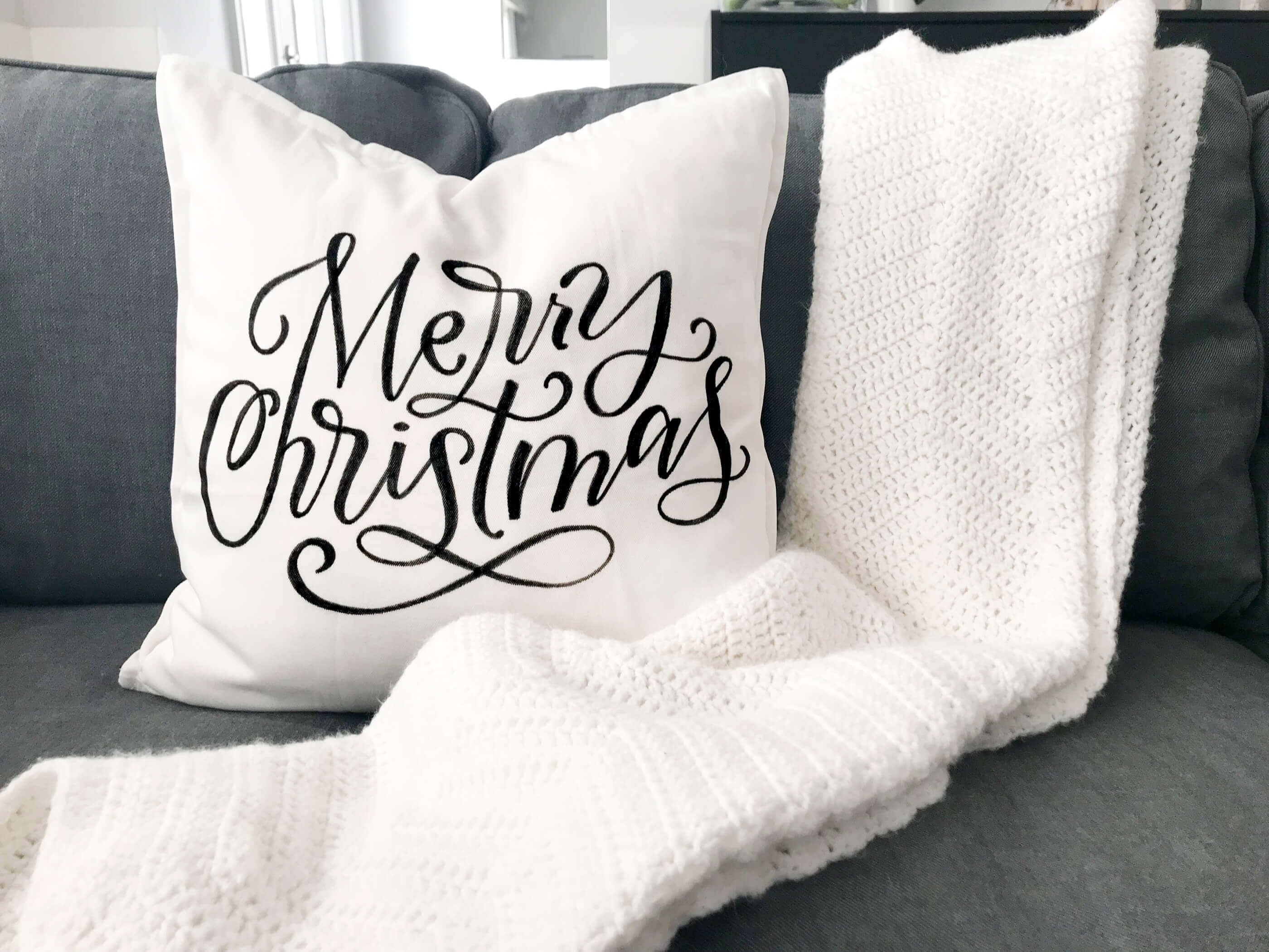 DIY Tutorial for making your own hand lettered Christmas throw pillow with four free printable tracers at amandaarneill.com